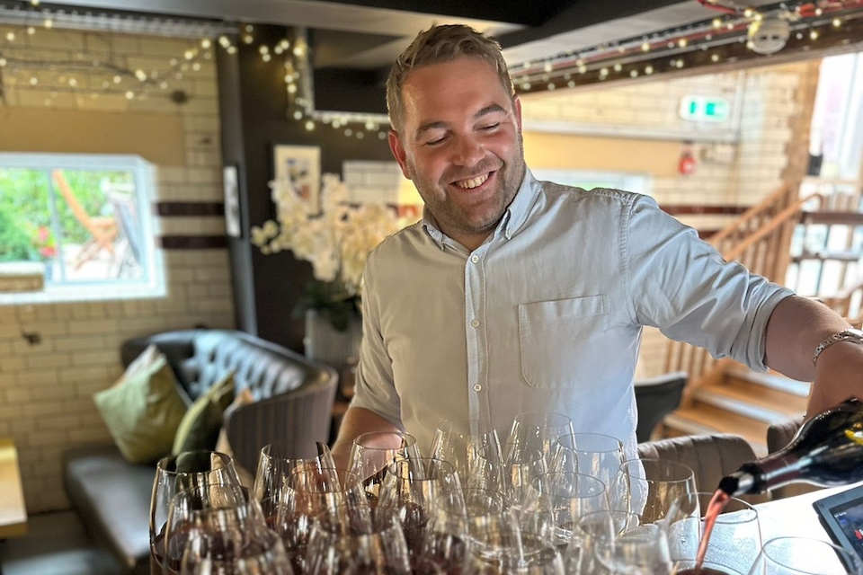 Old Liquor Store host pouring red wine