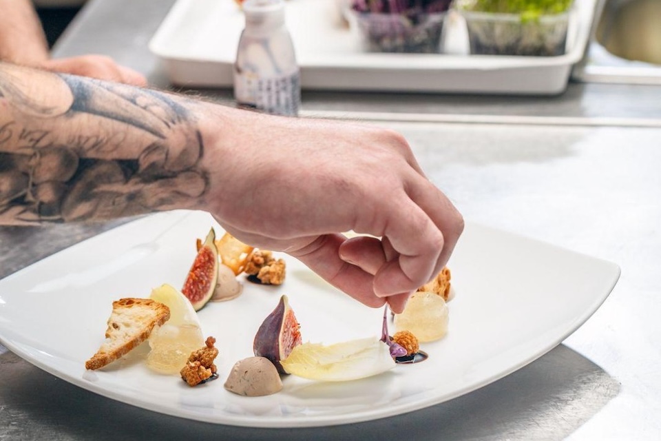 Chef plating up food at Selena's 